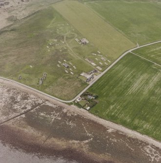 Hoy, Doonatown, oblique aerial view, taken from the SE, centred on The Garrison Theatre, Lyness Military Headquarters and Camp, and a ruined farmstead.