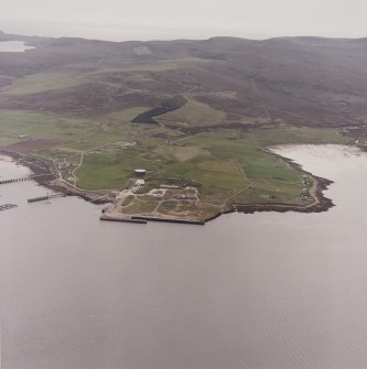 Hoy, Lyness, oblique aerial view, taken from the ENE, centred on the Royal Navy Oil Terminal. Visible in the top half of the photograph is Wee Fea Naval Signal Station.