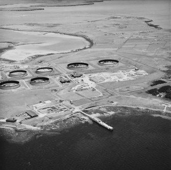 Oblique aerial view from NNW, showing the oil terminal in the centre of the photograph.