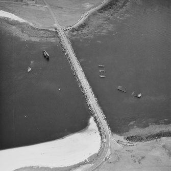 Oblique aerial view from N, centred on the barrier and the wrecks of the blockships Reginald, Empire Seaman and Martis.