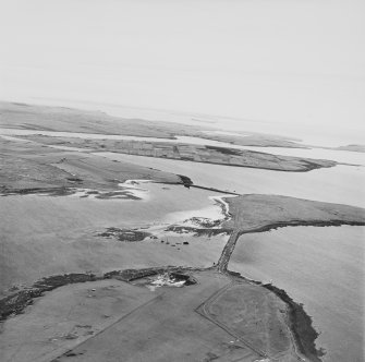 Oblique aerial view from NE, centred on Barriers No. 2 and 3, and showing Lamb Holm quarry and Battery in the bottom left-hand corner of the photograph.