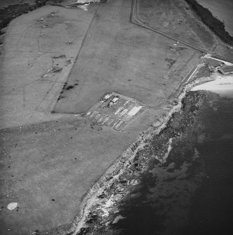 Oblique aerial view, taken from the NE, centred on The Italian Chapel, and adjacent Military Camp.