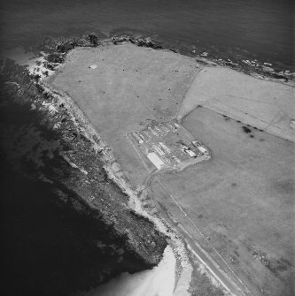 Oblique aerial view, taken from the WNW, centred on The Italian Chapel, and adjacent Military Camp.
