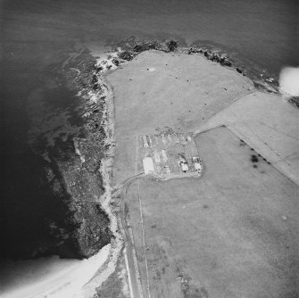 Oblique aerial view, taken from the WSW, centred on The Italian Chapel, and adjacent Military Camp.