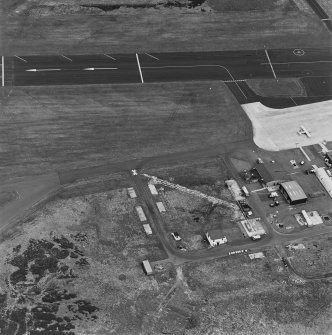 Oblique aerial view from SW.  Visible are several concrete hut bases, Nissen hut and modern additions.