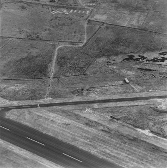 Oblique aerial view from W.  Visible are two protected dispersal bays, with part of the Longtownmail accommodation camp in the background.