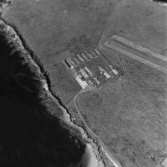 Oblique aerial view of Orkney, Lamb Holm, Italian Chapel and the remains of the prisoner-of-war camp, from W.