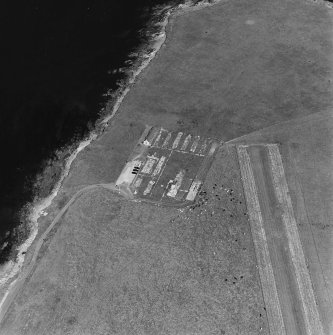 Oblique aerial view of Orkney, Lamb Holm, Italian Chapel and the remains of the prisoner-of-war camp, from WSW.
