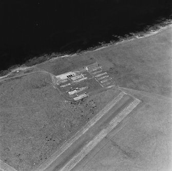 Oblique aerial view of Orkney, Lamb Holm, Italian Chapel and the remains of the prisoner-of-war camp, from SW.