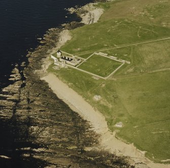 Oblique aerial view of Orkney, Graemsay, Hoy Sound Lighthouse and Graemsay coast battery, taken from the SW.