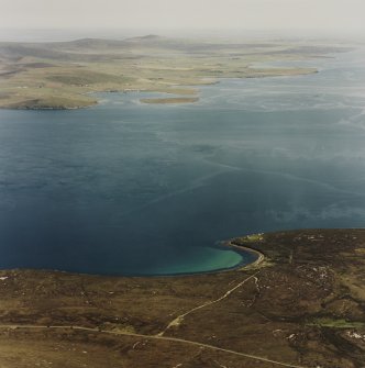 Oblique aerial view of Scad Head, general view over the Bring Deeps looking to mainland Orkney, of Second World War coastal battery, gun emplacements, observation post and searchlight positions, taken from the SW.  Also visible is the tramway connecting the public road to the battery.