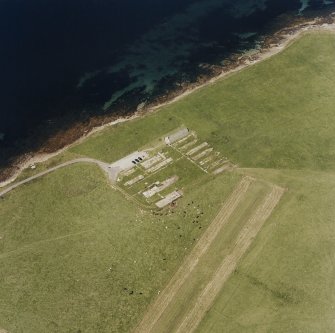 Oblique aerial view of Orkney, Lamb Holm, Italian Chapel and the remains of the prisoner-of-war camp, taken from the SW.