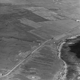 Oblique aerial view of an engine house, one searchlight emplacement and the site of the accommodation camp, taken from the SW.