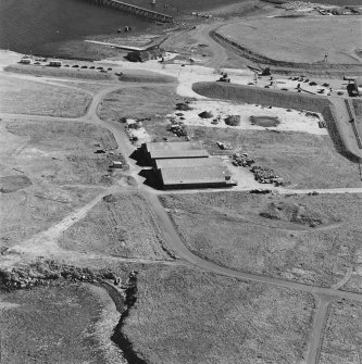 Oblique aerial view of Orkney, Hoy, Lyness, Royal Naval Oil terminal, of part of the RN base and the Scapa Flow Museum, formerly the main boiler house.