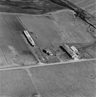 Oblique aerial view of Orkney, Hoy, Lyness, Royal Naval Oil terminal, view from WNW, of E part of the accommodation camp, ancillary buildings to the E of the road.
