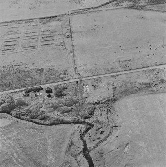 Oblique aerial view of Orkney, Hoy, Lyness, Royal Naval Oil Terminal, view from E, concrete hut bases of the RMAU camp and part of the site of the RME camp.