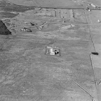 Oblique aerial view of Orkney, Hoy, Lyness, Royal Naval Oil terminal, view from SSW, of the Pumphouse for the underground oil tanks.  The Naval Cemetery is visible in the background.