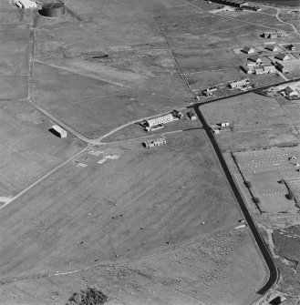 Oblique aerial view of Orkney, Hoy, Lyness, Royal Naval Oil terminal, view from NW, of part of the Naval Cemetery and a pillbox.  Also visible are are some of the ancillary buildings in the N part of the Naval Base.