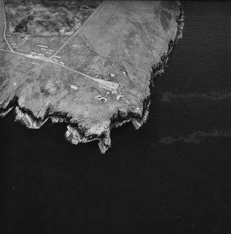 Oblique aerial view, taken from the WSW, centred on Hoxa Battery and Military Camp.