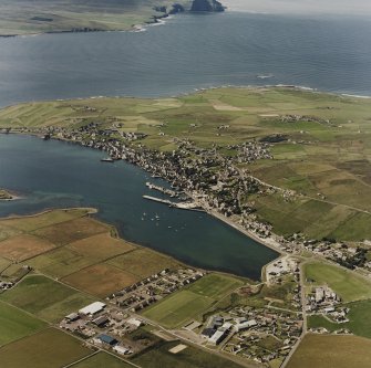 Aerial view of Stromness town and harbour, taken from the NE.  Visible in the background is the Island of Hoy