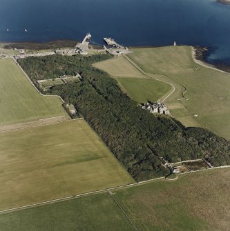 Oblique aerial view of Orkney, Shapinsay, Balfour Castle and walled garden, Balfour village, harbour with the Dishan Tower dovecot, taken from the WNW.