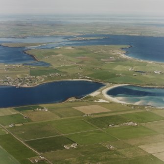 Oblique aerial view of Orkney, Burray, general view taken from the S of Burray, Burray village and all four Churchill Barriers.