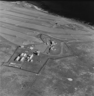Oblique aerial view of Orkney, taken from the NW of Ness WW II coast battery and accommodation camp with Ness WWI coast battery and Links WWII coast battery in the background.