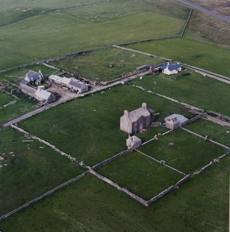 Oblique aerial view centred on the house, farmstead and cottage taken from the SW