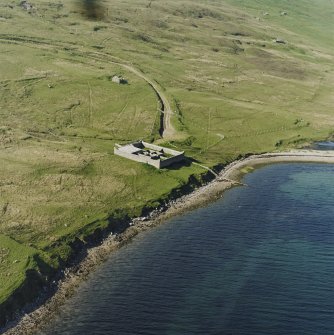 Oblique aerial view centred on the pony pound and the remains of the enclosures with the remains of the croft building and the building and enclosure adjacent, taken from the SW