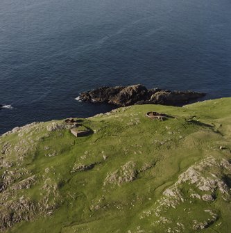 Oblique aerial view centred on the remains of the coast battery, gun emplacements and magazines, taken from the S.