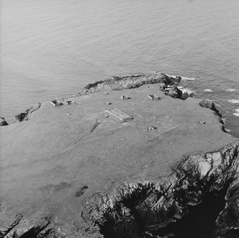 Oblique aerial view centred on the remains of the radar station, taken from the NNE.