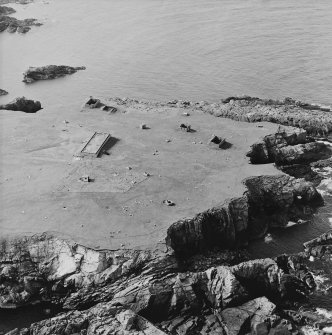 Oblique aerial view centred on the remains of the radar station, taken from the SE.