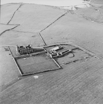 Oblique aerial view centred on the remains of the farmhouse, farmsteading and walled garden, taken from the SSE