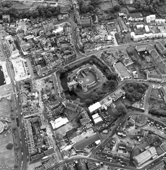 Oblique aerial view of Rothesay, taken from the NW, centred on a castle.  The photograph gives a general view of the town.