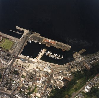 Oblique aerial view centred on the harbour, taken from the SSE.