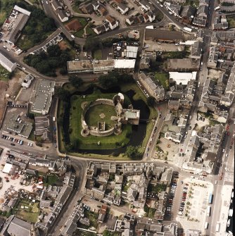 Oblique aerial view of Rothesay centred on the remains of the castle and chapel, taken from the E.