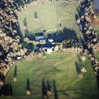 Oblique aerial view centred on the country house, walled garden and farmstead with the remains of the cairn adjacent, taken from the SW.