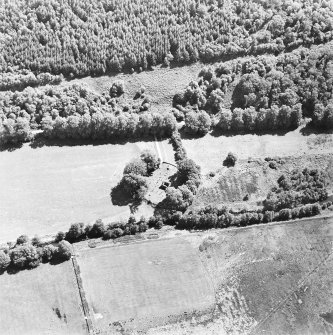 Oblique aerial view centred on the remains of the chapel and burial ground, taken from the NW.