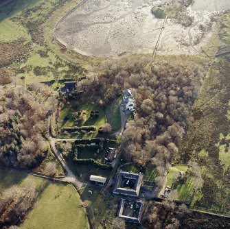 Oblique aerial view centred on the castle and the farmstead, taken from the NNE.