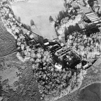 Oblique aerial view centred on the castle and the farmstead, taken from the SW.