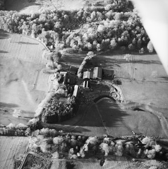 Oblique aerial view centred on the country house, walled garden and farmstead with the remains of the cairn adjacent, taken from the SE.