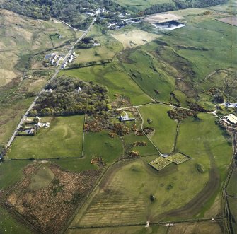 Oblique aerial view centred on the burial-ground, church and manse with the house and village adjacent, taken from the SW.
