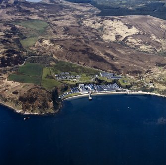 Oblique aerial view centred on the whisky distillery, housing and schoolhouse, taken from the NE.
