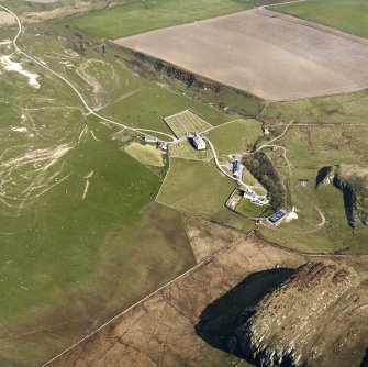 Oblique aerial view of Kilchoman centred on the church, burial-grounds and manse, taken from the S.