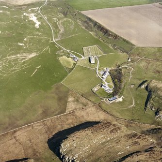 Oblique aerial view of Kilchoman centred on the church, burial-grounds and manse, taken from the SSE.
