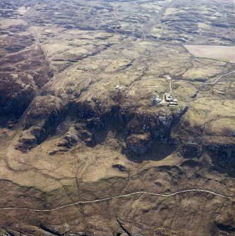 Oblique aerial view centred on the radar station and the remains of the dun, taken from the NW.