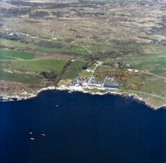 Oblique aerial view centred on the whisky distillery and pier, taken from the SE.