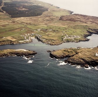 General oblique aerial view centred on the villages, lighthouse, cottage and remains of the chapel and burial ground, taken from the WSW.