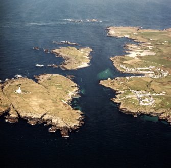 General oblique aerial view centred on the villages, lighthouse, cottage and remains of the chapel and burial ground, taken from the SE.