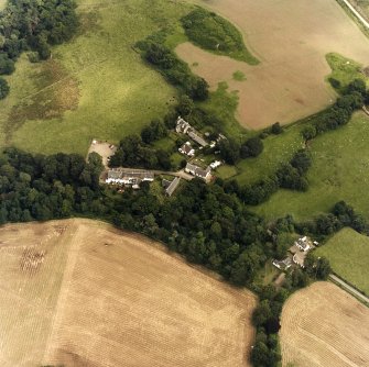 Oblique aerial view centred on the church, churchyard and hotel, taken from the WSW.